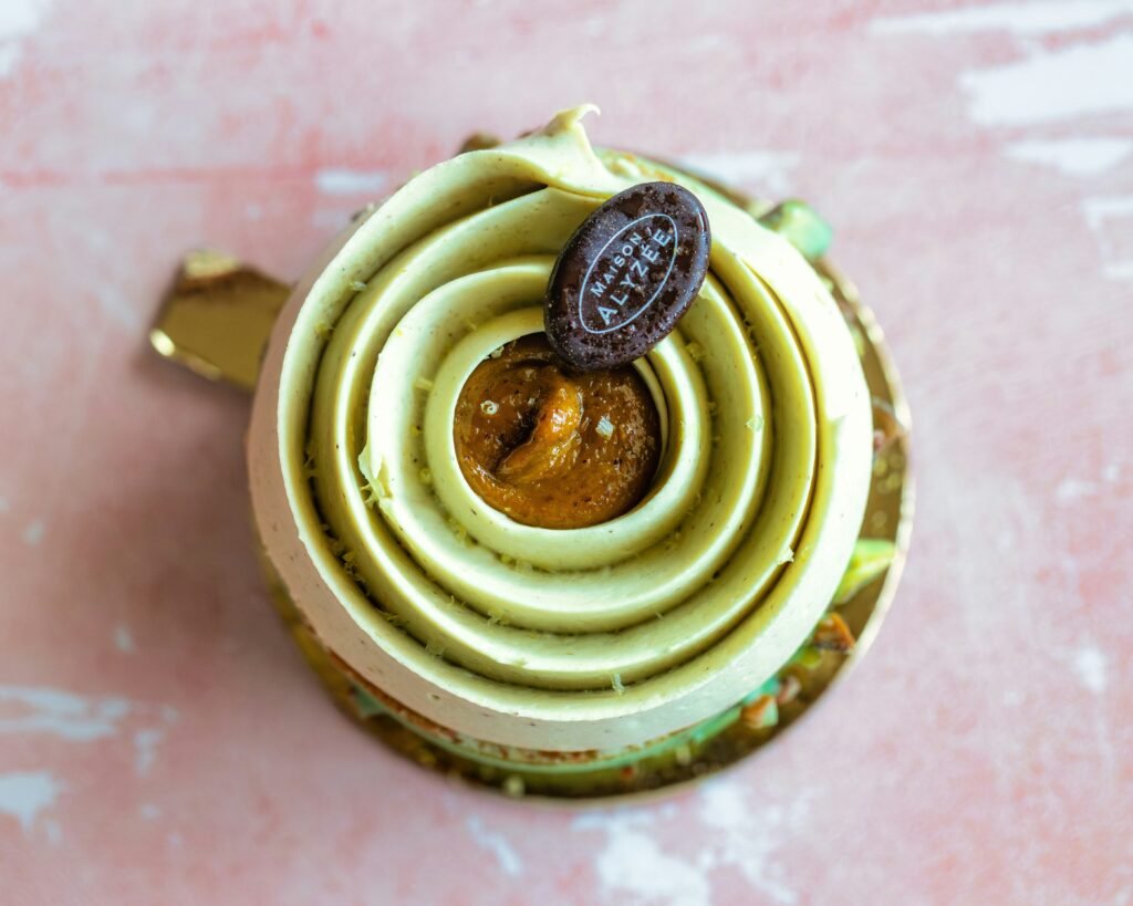 Dubai Pistachio Kunafa Cake with green pistachio piping and chocolate disc - Vegan Cakes Atelier Thanisandra Bangalore