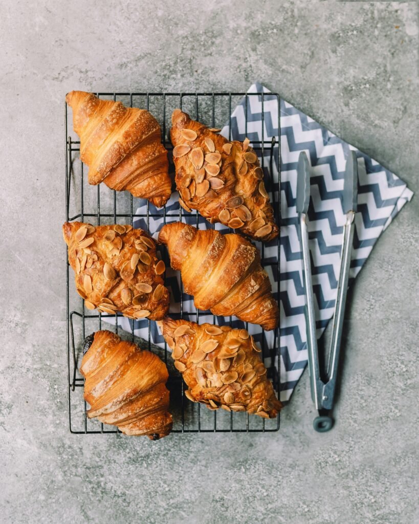 Golden flaky Vegan Croissants on a cooling rack - Vegan Cakes Atelier Thanisandra Bangalore