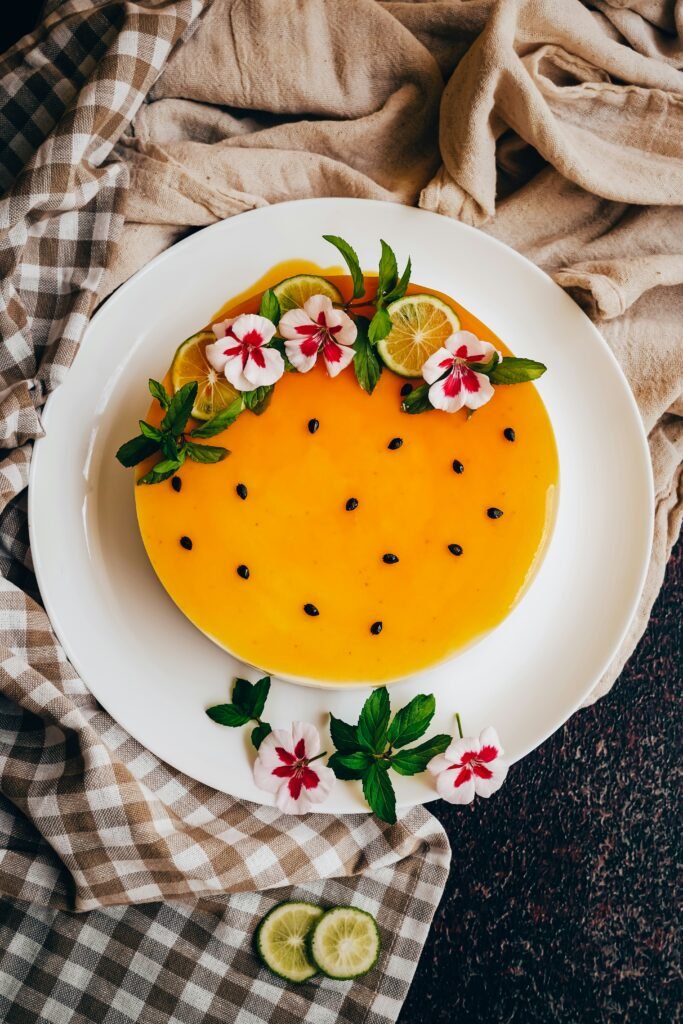 Fresh Mango Creamy Vegan Cake with floral decor and passion fruit seeds - Vegan Cakes Atelier Thanisandra Bangalore